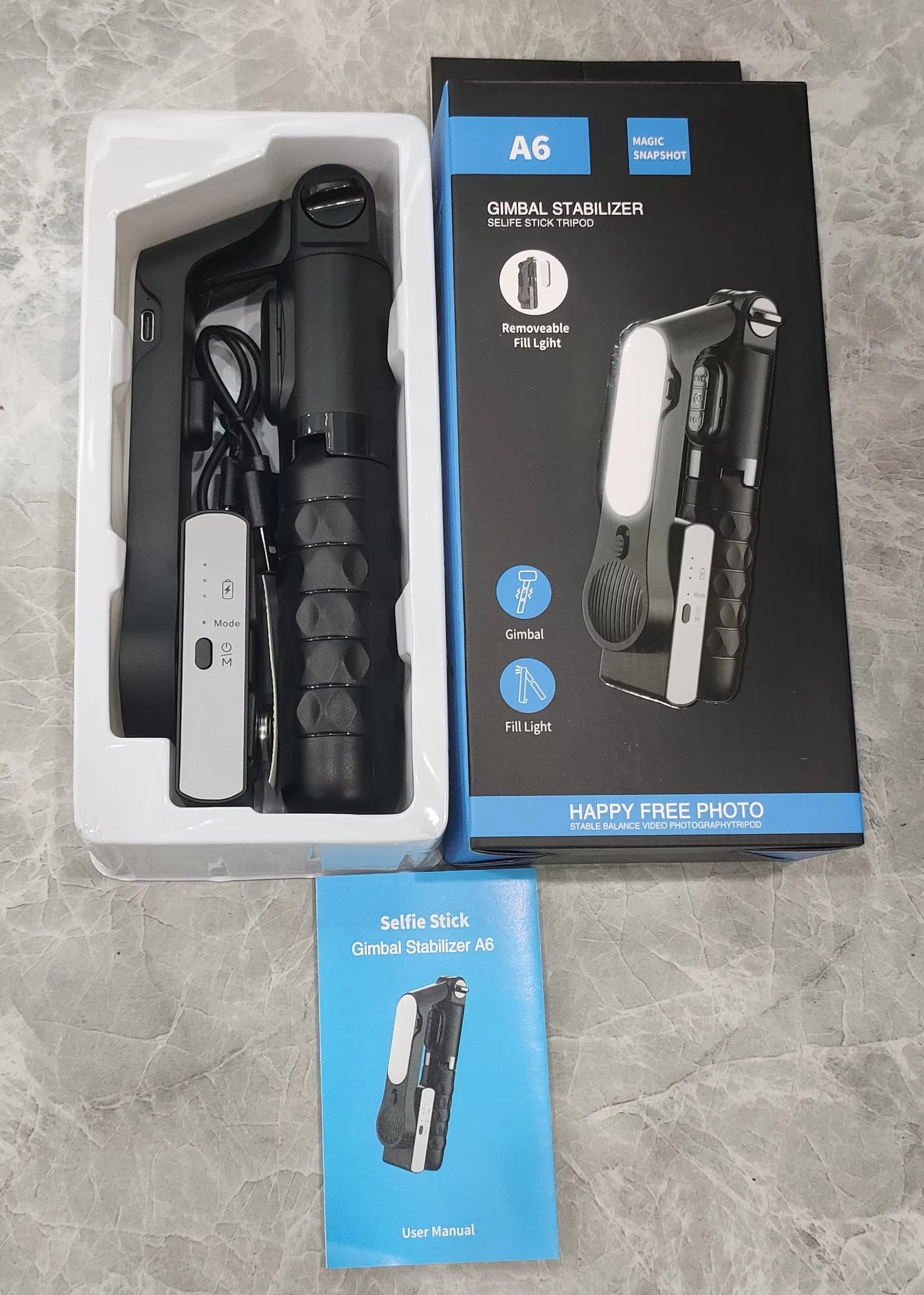 Gimbal stabilizer with packaging on a gray surface